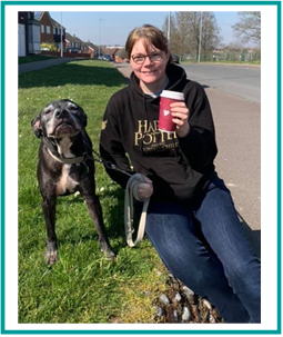 Vetsure's Claims Assessor Jacqueline sits with her Staffordshire Bull Terrier and drinks a coffee.